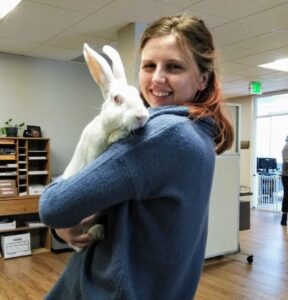 Caucasian female holding white rabbit